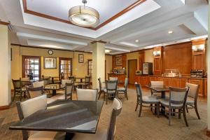 a restaurant with tables and chairs in a room at Best Western Plus Clearfield in Clearfield