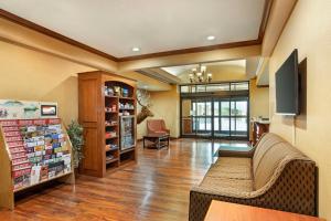 a lobby of a pharmacy with a couch and a tv at Best Western Plus Clearfield in Clearfield