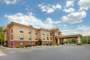 a hotel with a parking lot in front of a building at Best Western Plus Clearfield in Clearfield