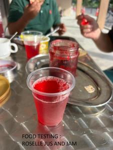 a table topped with a red drink in a cup at GLG KLIA Transit House in Sepang