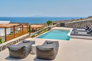 a villa with a swimming pool with a view of the ocean at 180 Suites in Imerovigli