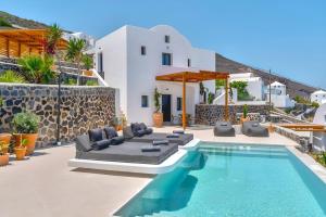 a villa with a swimming pool and a house at 180 Suites in Imerovigli