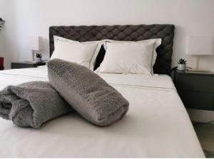 uma cama com dois travesseiros em cima em Vila Miona Apartments em Belgrado