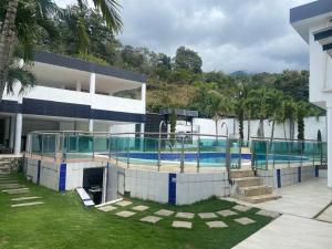 a large building with a swimming pool in front of it at Villa Cami in La Mata