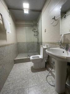 a bathroom with a toilet and a sink at nur m hotel in tashkent in Yakkasaray