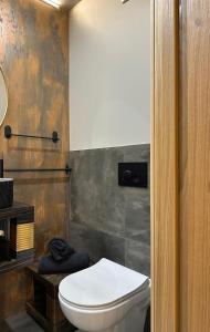 a bathroom with a white toilet in a room at Hugo Airport in Mārupe