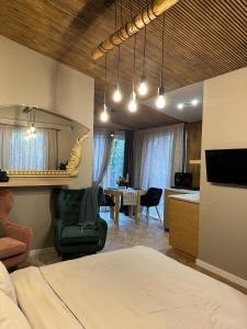 a bedroom with a bed and a dining room at Hugo Airport in Mārupe