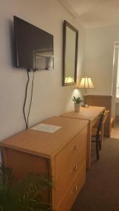a desk with a flat screen tv on a wall at Beltway Motel and Suites in Halethorpe