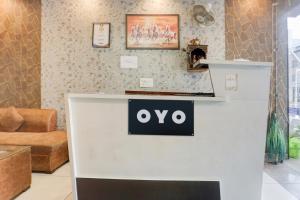 a white counter with a sign on it in a room at SPOT ON Hotel Umang in Zirakpur