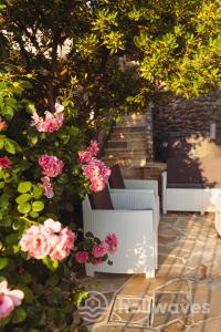 a group of chairs and flowers on a patio at La casa di Luisa in Moneglia