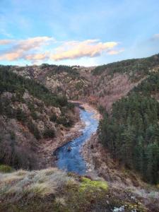 a view of a river in the middle of a mountain at L'envol des papillons in Lafarre
