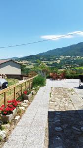 a patio with tables and chairs and flowers at Villetta Vittoria Country House. La depandance in Pennabilli