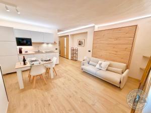 a living room with a couch and a table at Madesimo Ski Suite in Madesimo
