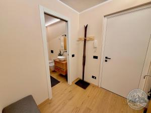 a hallway with a door leading to a bathroom at Madesimo Ski Suite in Madesimo