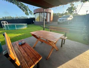 a picnic table and a bench on a patio at The Glamp - Homagama in Talagala +6 photos