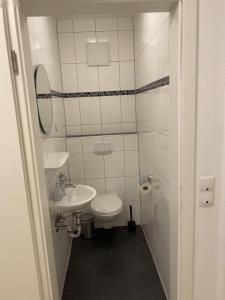 Un baño pequeño con inodoro y lavabo. en Sternenhimmel, en Wangerland 9 fotos más