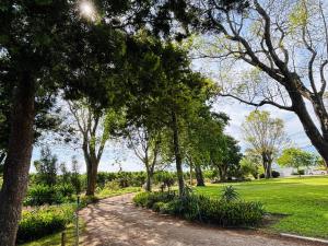 a path through a park with trees and grass at Addo Good Hope Guest House in Sunland
