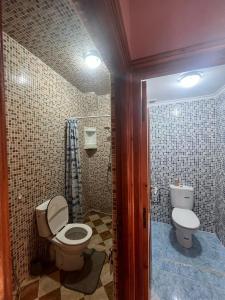 a bathroom with a toilet and a sink at Surf capitain in Tamraght Ouzdar +15 photos