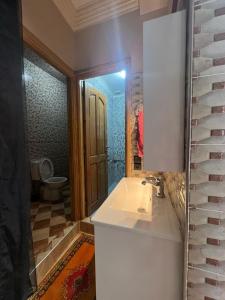 a bathroom with a sink and a toilet at Surf capitain in Tamraght Ouzdar