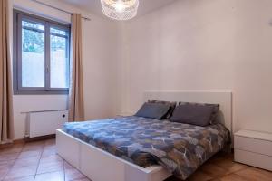 a bedroom with a bed in a room with a window at Ticinum House in Pavia