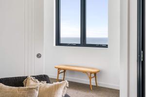 a table in the corner of a room with a window at 803 - Stylish Retreat - Ocean Views & Parking in Newcastle
