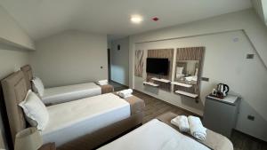 a hotel room with two beds and a television at Мотел Ханай 