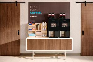 a coffee shop with a counter with a coffee maker on it at Holiday Inn Express Flagstaff by IHG in Flagstaff