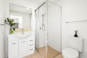 a white bathroom with a toilet and a sink at 901 - Perfect Penthouse - With Free Parking in Newcastle +3 photos