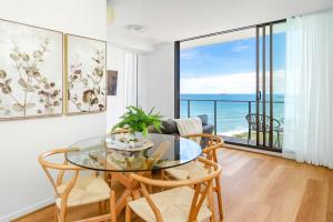 a dining room with a glass table and chairs at 901 - Perfect Penthouse - With Free Parking in Newcastle