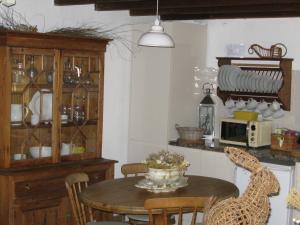 a kitchen with a table and a dining room at Romantic Cottage Retreat for Two in South Vienne in Champniers