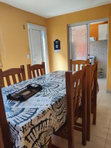 a dining room table with a blue and white table cloth at Kaike in Caleta Olivia