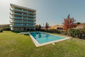a swimming pool in a yard next to a building at Amazing Pool Apartments by Vacationy in Vila Nova de Gaia