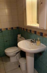 a bathroom with a sink and a toilet and a mirror at Los Llanos Ocean view in Los Llanos de Aridane +15 photos