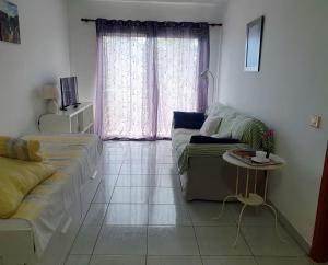 a living room with a couch and a table at Los Llanos Ocean view in Los Llanos de Aridane