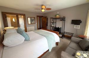 a bedroom with a large white bed and a couch at Inn 31 in Kingsville