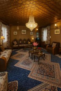 a living room with a couch and a chandelier at Floating Luxury Group Of Houseboats in Srinagar
