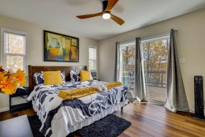 a bedroom with a bed and a ceiling fan at Lakefront Pocono Retreat with Hot Tub and Movie Hub in Pocono Summit Estates +33 photos