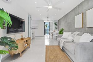 a living room with a couch and a table at Villa Layka Beach House at Playas del Yunque in Rio Grande