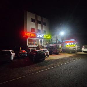 a hotel gas station at night with cars parked in front at Hotel G17 and Restaurant in Dhāmnod