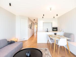 a living room with a couch and a table at Sable dArgent in Galopen +11 photos