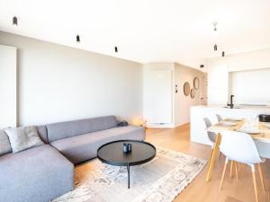 a living room with a couch and a table at Sable dArgent in Galopen