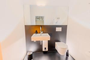 a bathroom with a sink and a toilet at SOON APT Nr 3 in Simmern