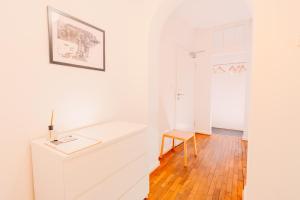 a white bathroom with a desk and a chair at SOON APT Nr 3 in Simmern