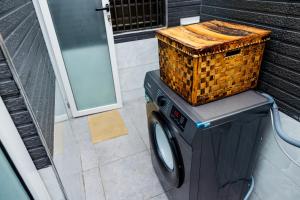 a washing machine with a basket on top of it at Luigi Homes in Kampala