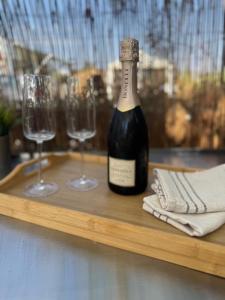 a bottle of wine on a wooden tray with two glasses at The Retreat - Armacao de Pera, Algarve Portugal in Pêra
