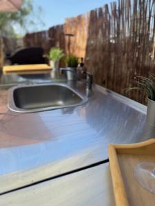 a kitchen counter with a sink and a window at The Retreat - Armacao de Pera, Algarve Portugal in Pêra