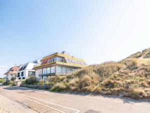 a house on top of a hill next to a road at Seawhisper in Galopen