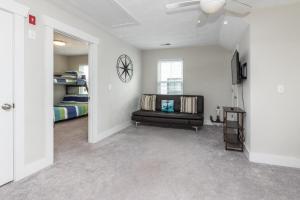 a living room with a couch and a bed at 525 The Back Bay House in Virginia Beach