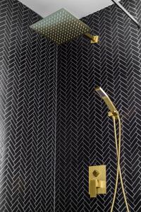 a bathroom with a shower with an umbrella on the wall at Prime Location Top Rated Clean Parking Free! in Columbus +36 photos