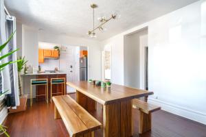 a kitchen with a wooden table and a bench at Prime Location Top Rated Clean Parking Free! in Columbus